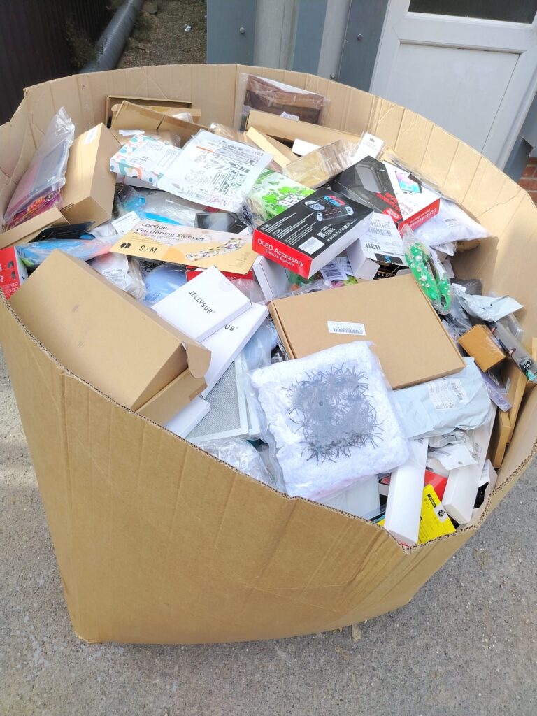 Bulk Amazon customer return goods pallet stacked high with mixed unmanifested inventory for wholesale clearance
