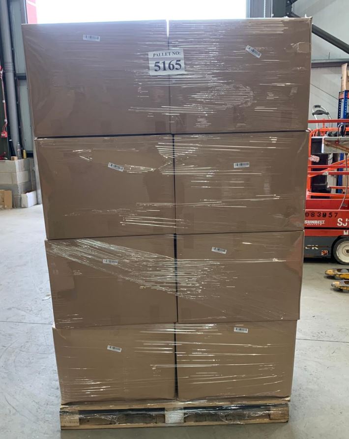 Stack of sealed brown cardboard master cartons stacked on a wooden delivery pallet, labeled with small domestic appliance icons.