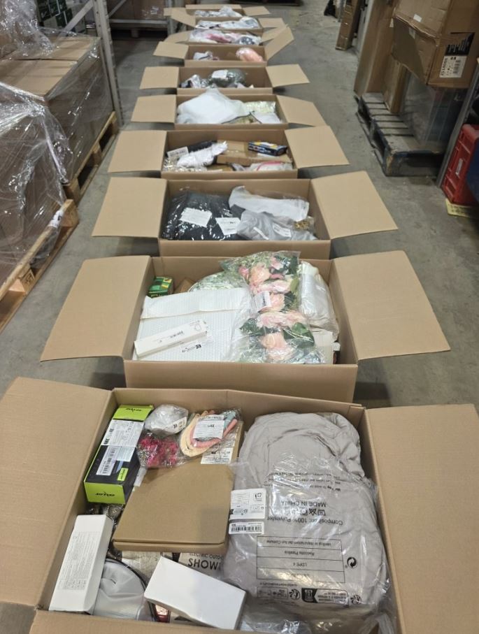High-density cardboard stock box filled with packaged trending kitchen gadgets, including compact blenders and air fryer accessories.