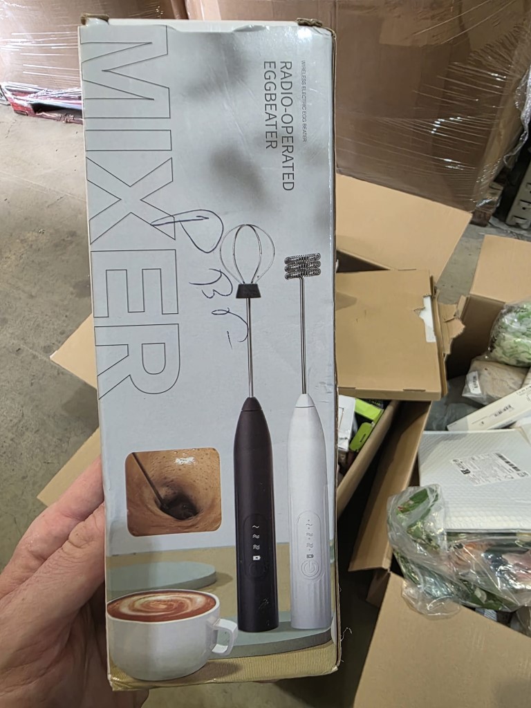 Large warehouse cardboard shipping box containing packaged smart home gadgets and novelty electronic items.