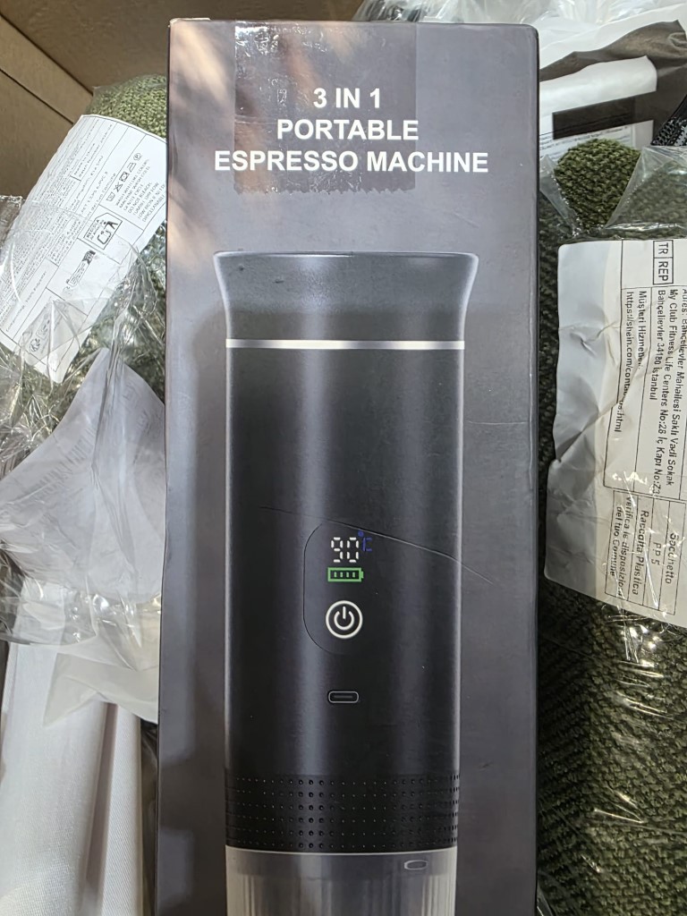 Heavy-duty cardboard box containing small domestic electrical appliances in original retail boxes.