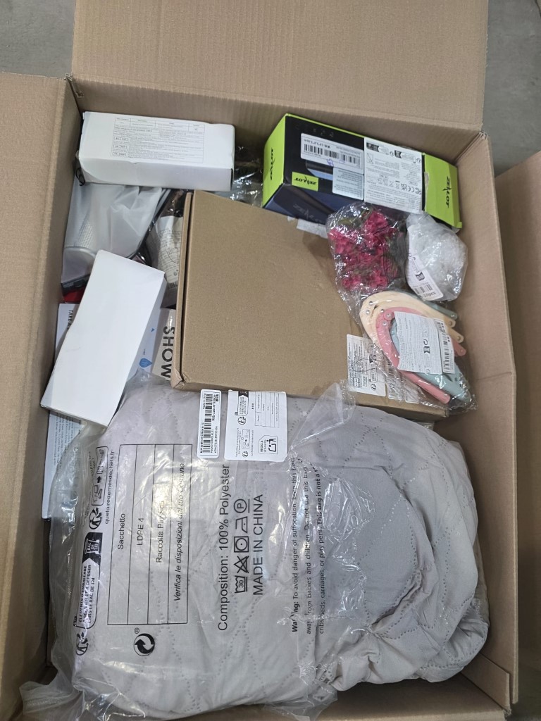 Warehouse carton containing compact home cleaning appliances and floor care gadgets.