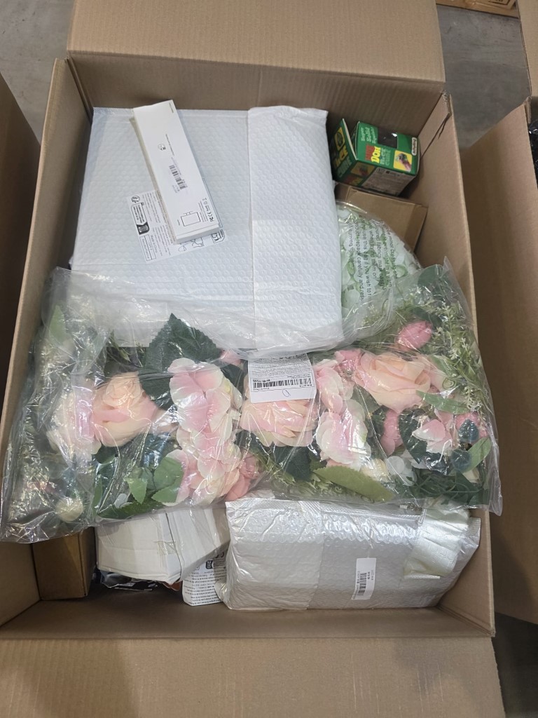 Bulk master box loaded with mixed seasonal gifts, novelties, and impulse items.