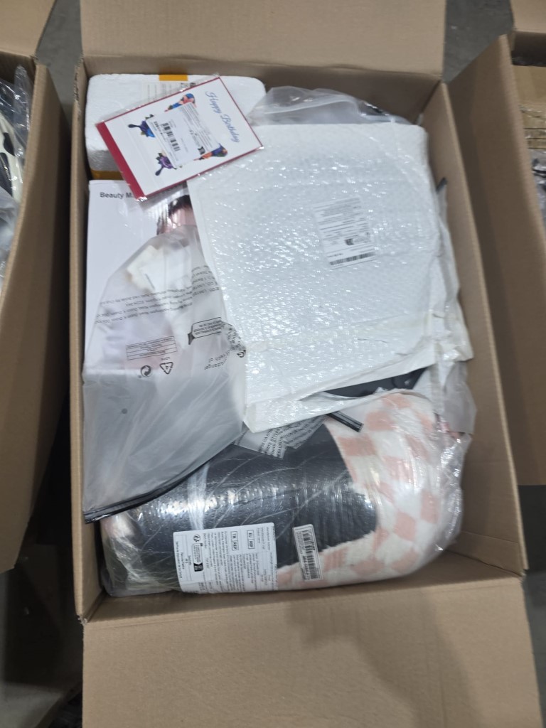 Pallet box filled with assorted retail stock, including boxed home goods and novelty gadgets.