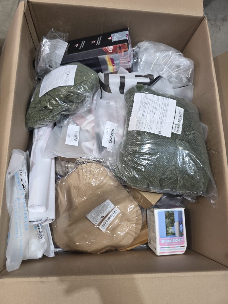 Large cardboard transit box loaded with mixed household clearance inventory and giftware.