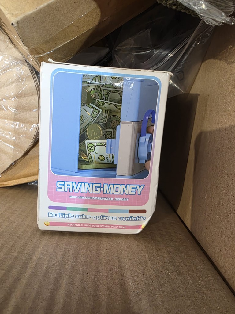 Cardboard transit case holding packaged cookware accessories.