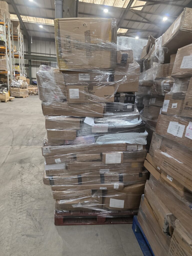 Assorted retail boxes and high-density goods on Amazon clearance pallet